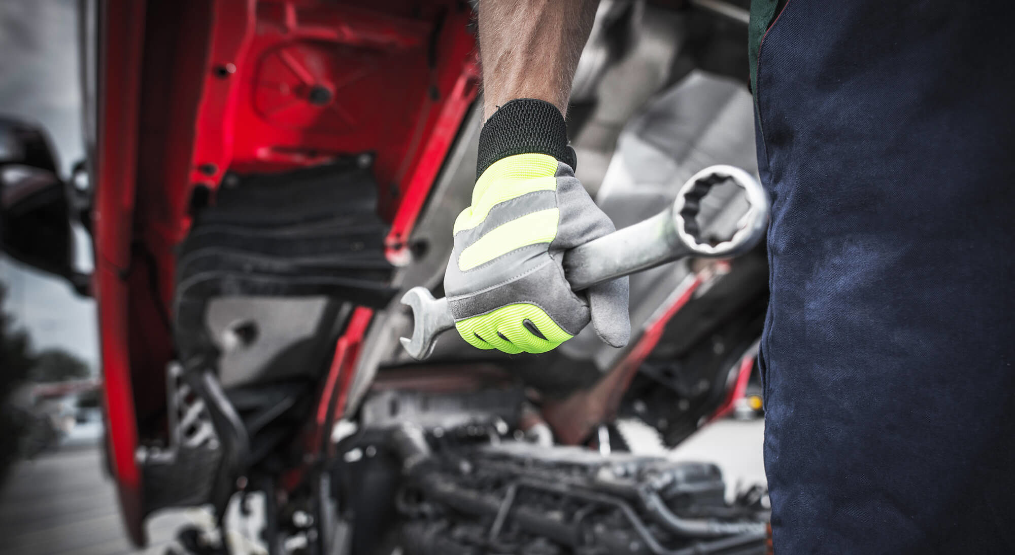 truck mechanic holding wrench closeup